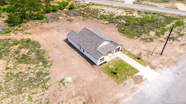 a view of a yard with wooden fence