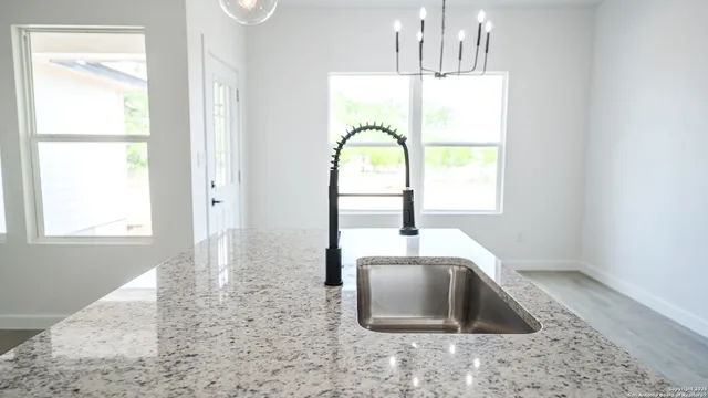 a kitchen with a window a sink and a counter top space
