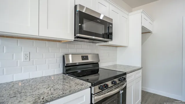 a kitchen with a stove and a microwave
