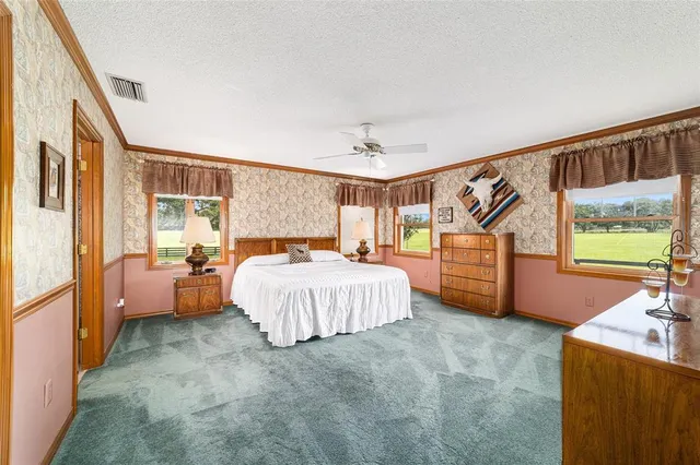 a spacious bedroom with a bed and a dresser