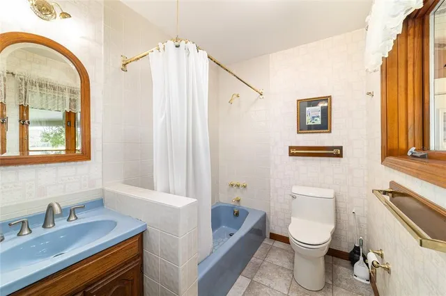 a bathroom with a sink a toilet and a bathtub