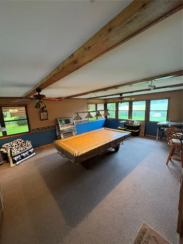 a bedroom with furniture and a large window