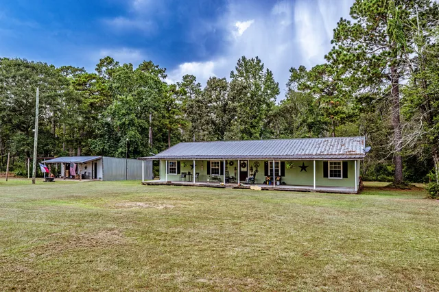 a view of a house with swimming pool and sitting area
