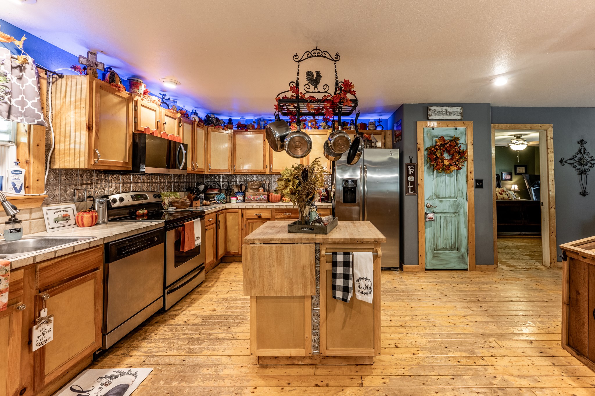 230 Thomas Creek Road Cleveland, TX 77328 - Photo 12 of 28 a kitchen with stainless steel appliances granite countertop a sink cabinets and wooden floor