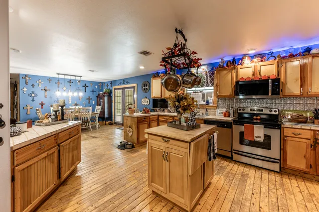 a kitchen with stainless steel appliances granite countertop a stove and cabinets