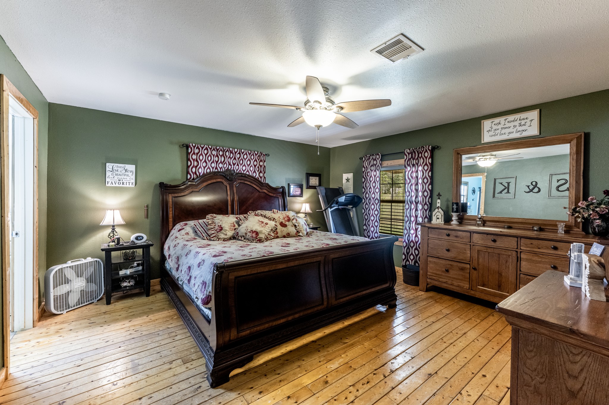 230 Thomas Creek Road Cleveland, TX 77328 - Photo 14 of 28 a bedroom with a large bed and a chandelier
