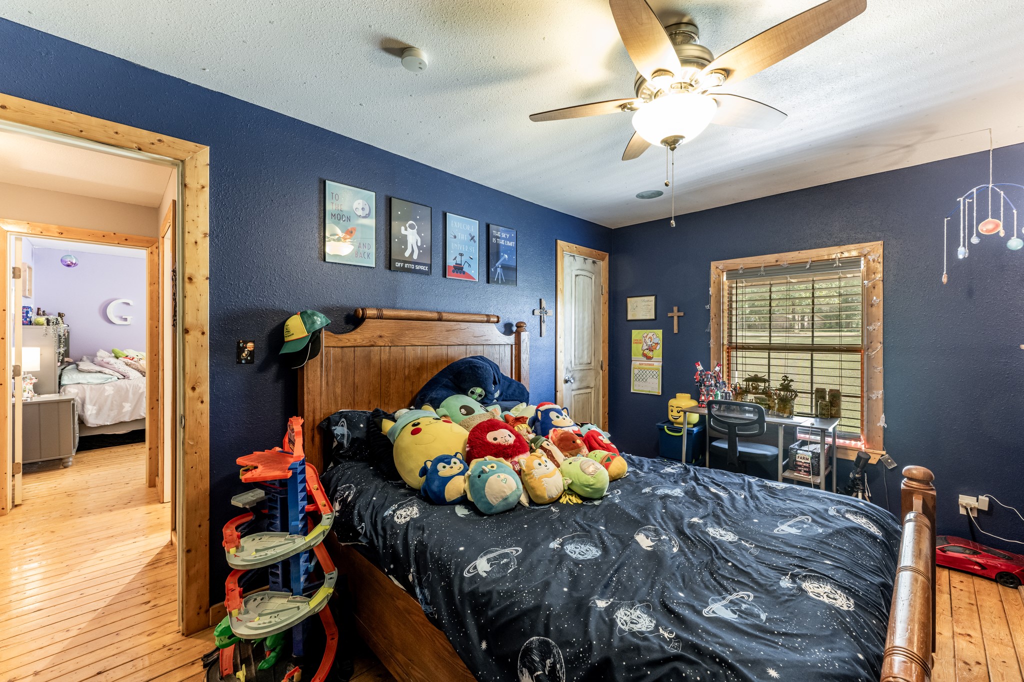 230 Thomas Creek Road Cleveland, TX 77328 - Photo 22 of 28 a bedroom with furniture and a chandelier