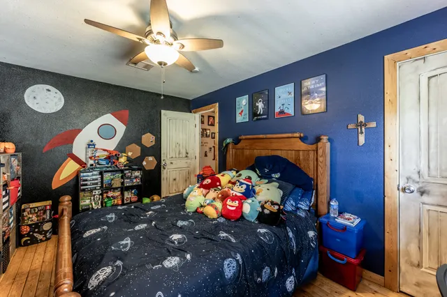 a bedroom with a bed and a chandelier