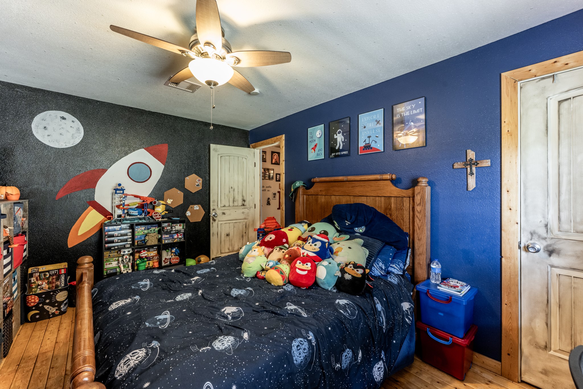 230 Thomas Creek Road Cleveland, TX 77328 - Photo 23 of 28 a bedroom with a bed and a chandelier
