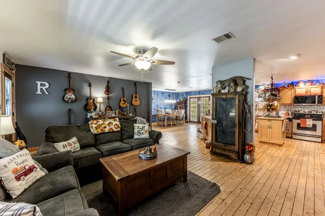 a living room with furniture and wooden floor