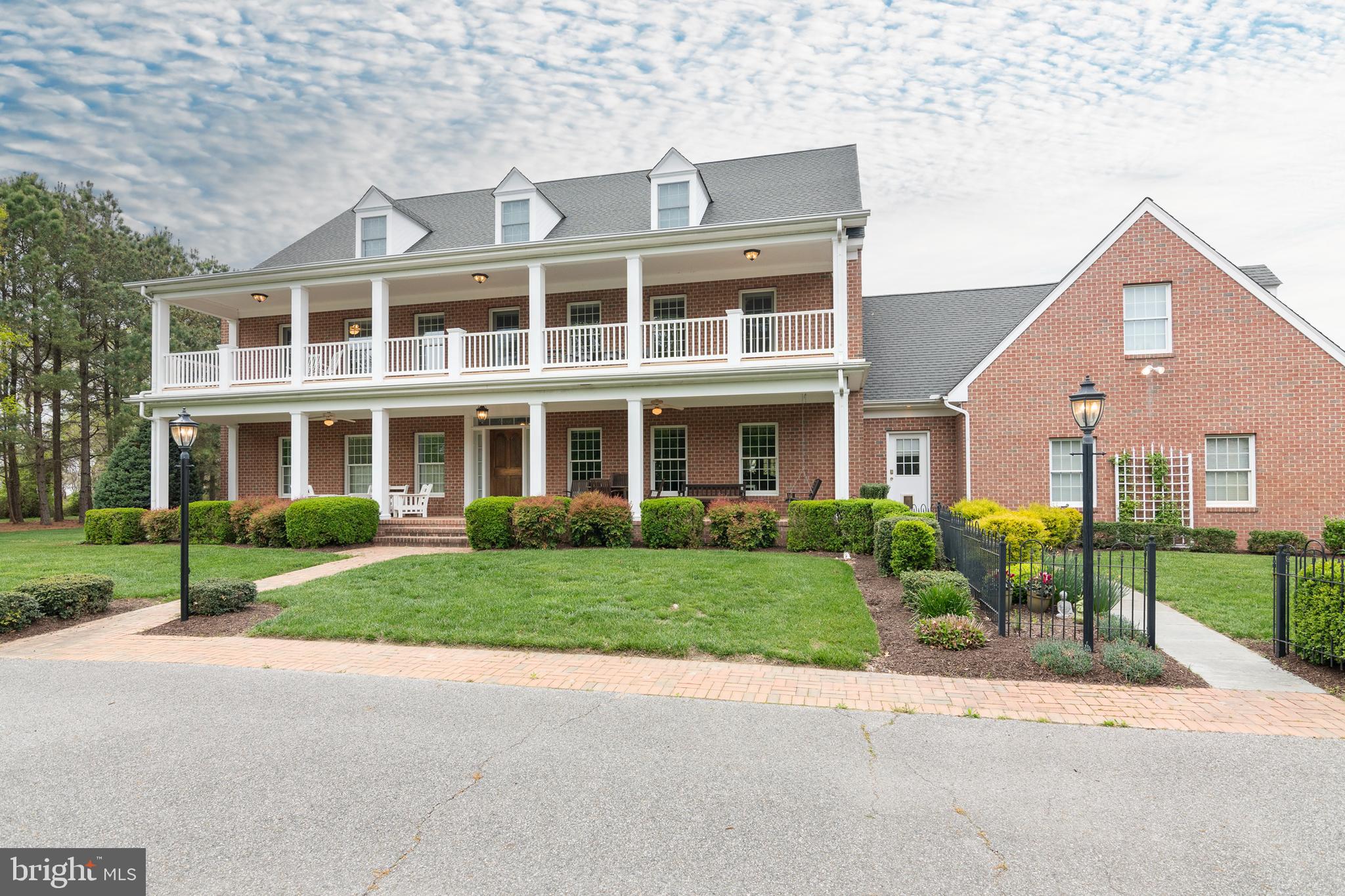 8781 Tilghman Island Road Wittman, MD 21676 - Photo 13 of 60 front view of a house next to a yard