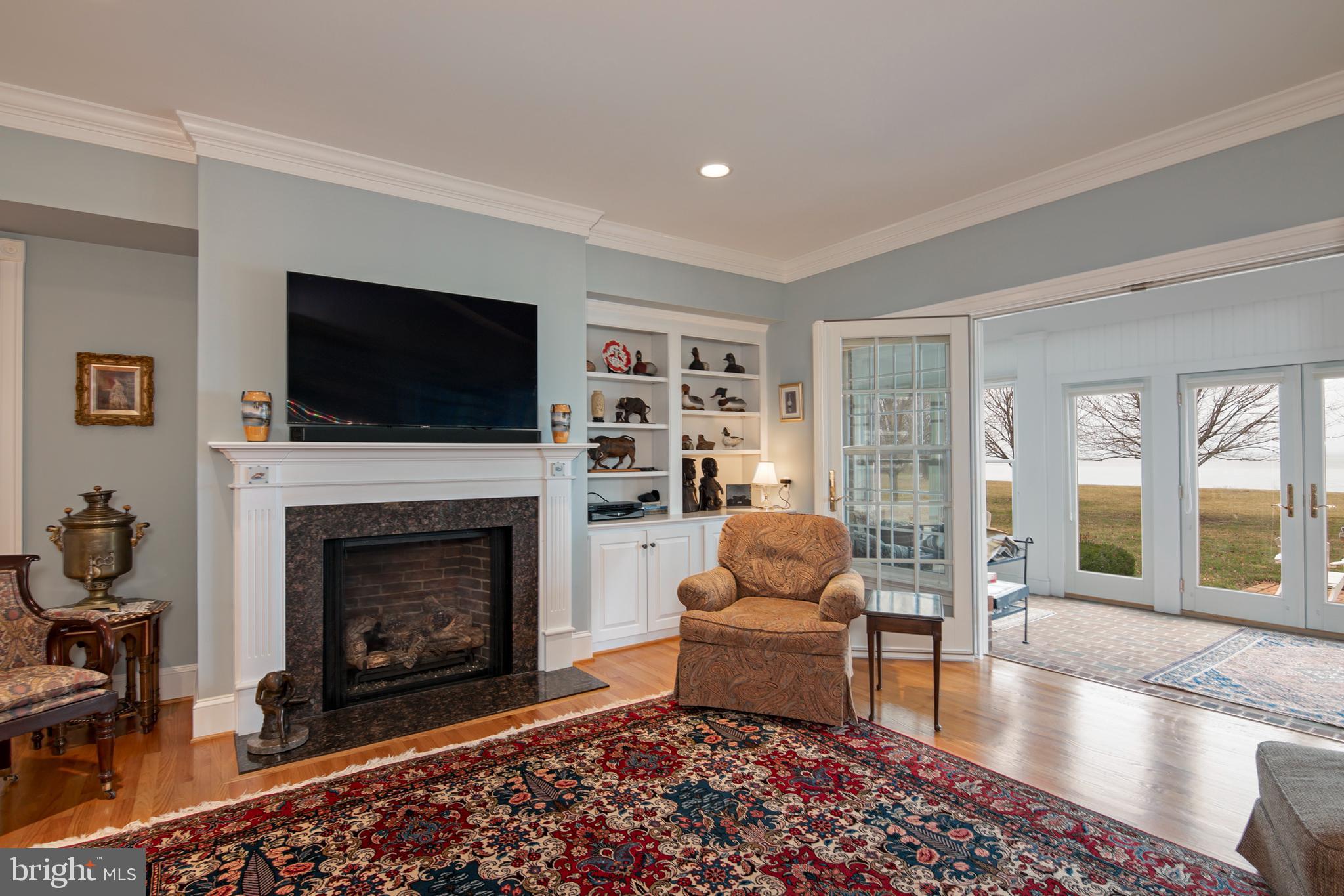 8781 Tilghman Island Road Wittman, MD 21676 - Photo 17 of 60 a living room with furniture a flat screen tv and a fireplace