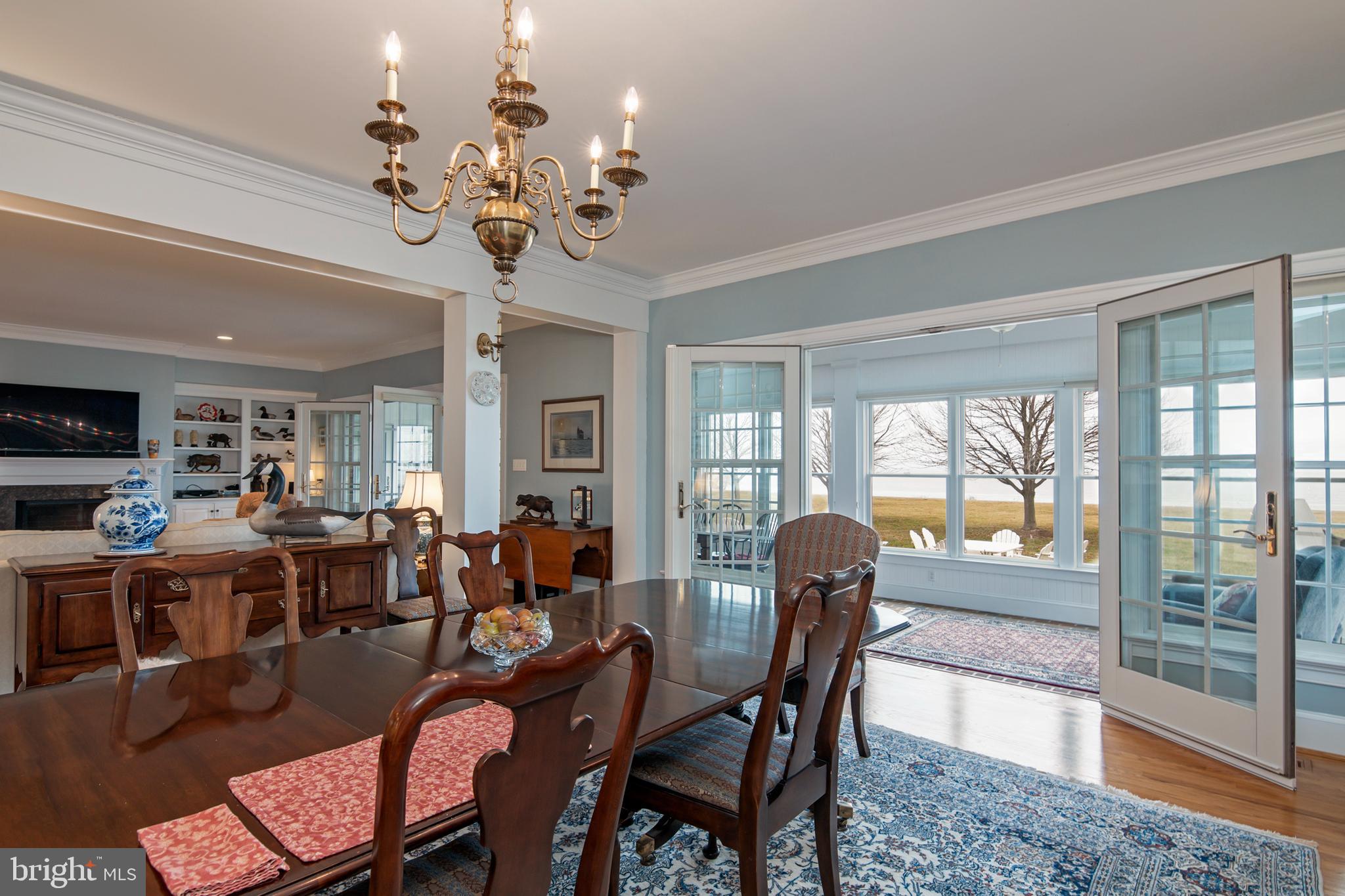 8781 Tilghman Island Road Wittman, MD 21676 - Photo 19 of 60 a view of a dining room with furniture wooden floor and chandelier