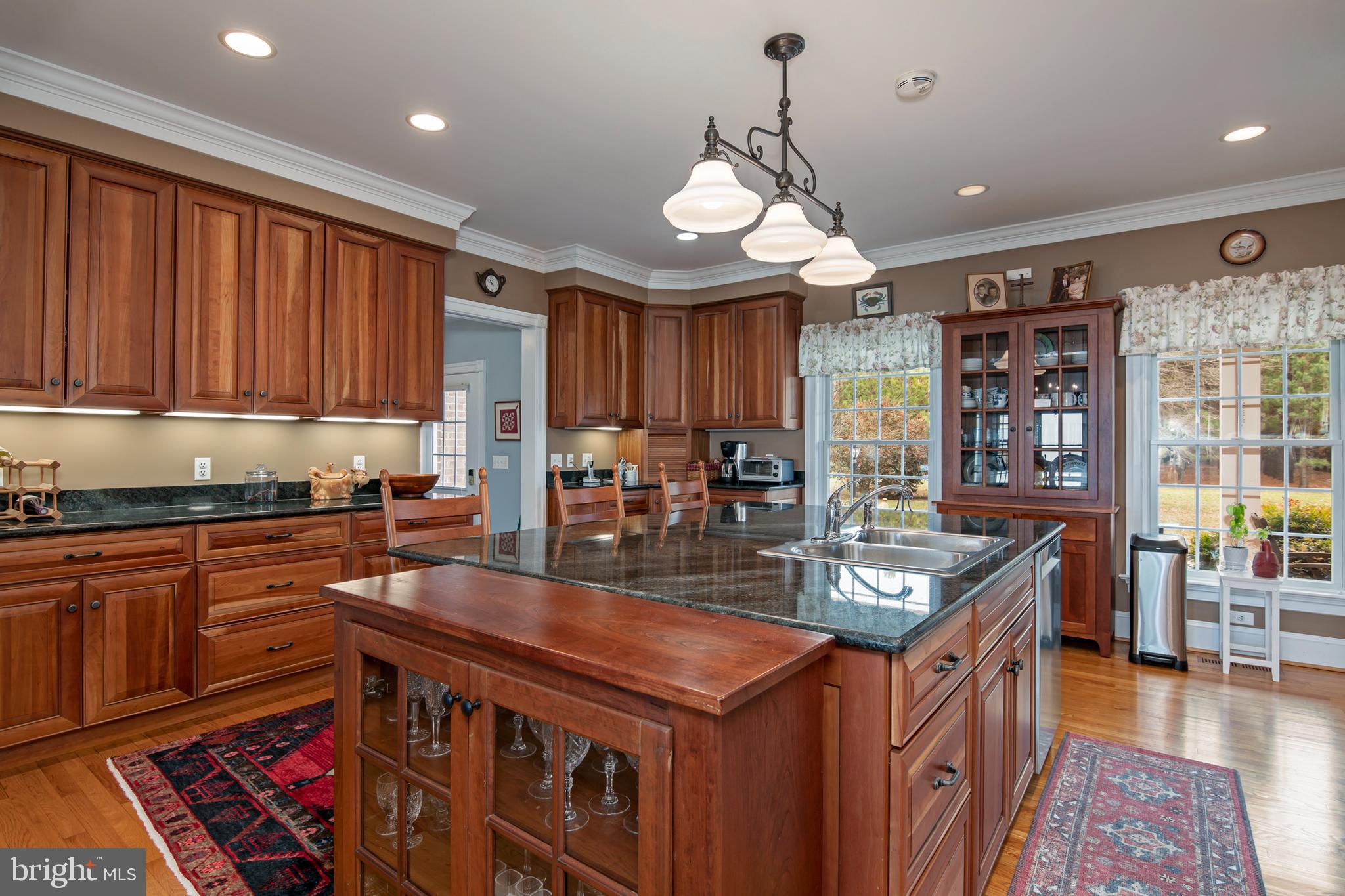 8781 Tilghman Island Road Wittman, MD 21676 - Photo 23 of 60 a kitchen with stainless steel appliances granite countertop a stove and cabinets