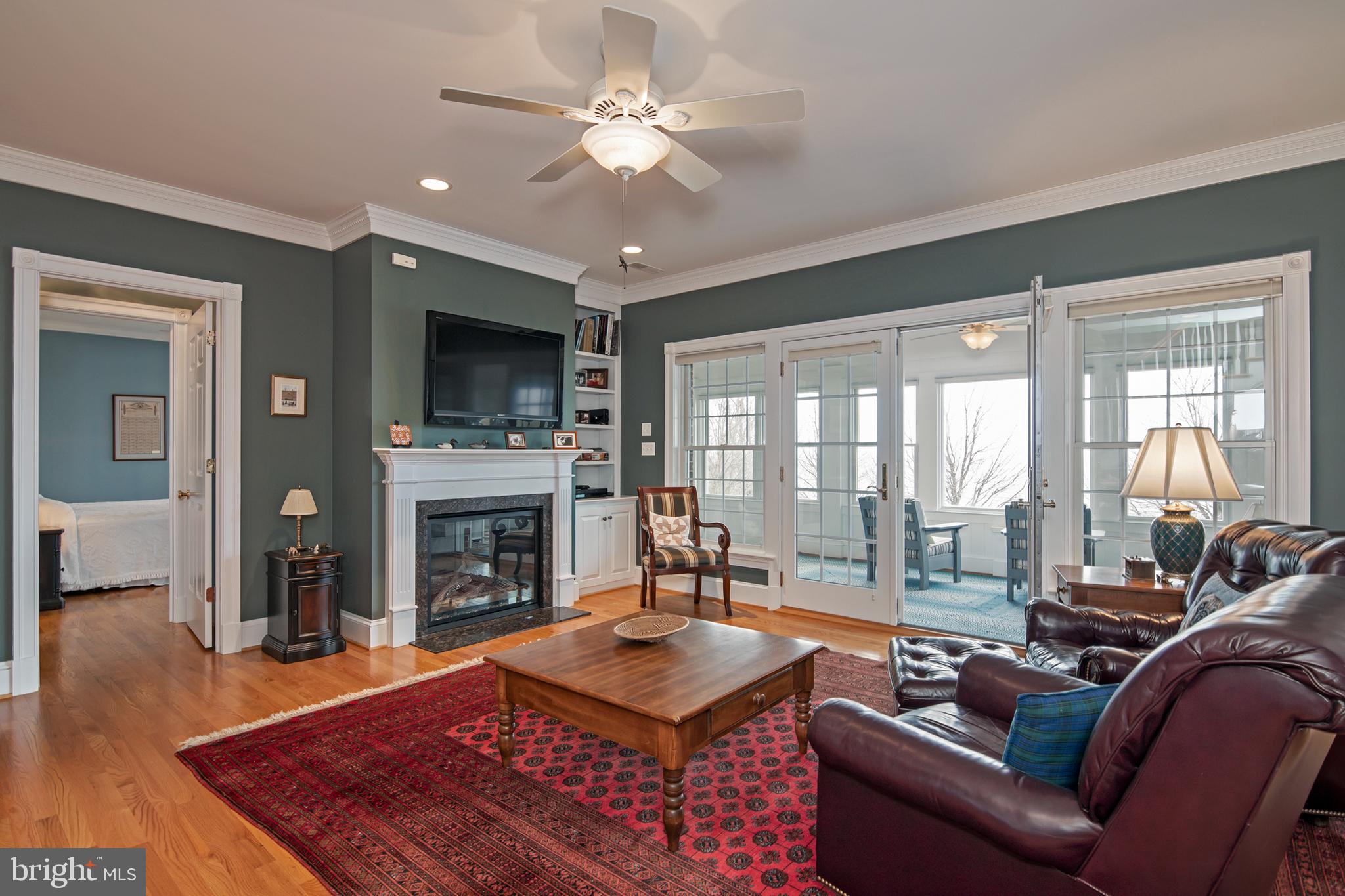 8781 Tilghman Island Road Wittman, MD 21676 - Photo 29 of 60 a living room with furniture a flat screen tv and a fireplace