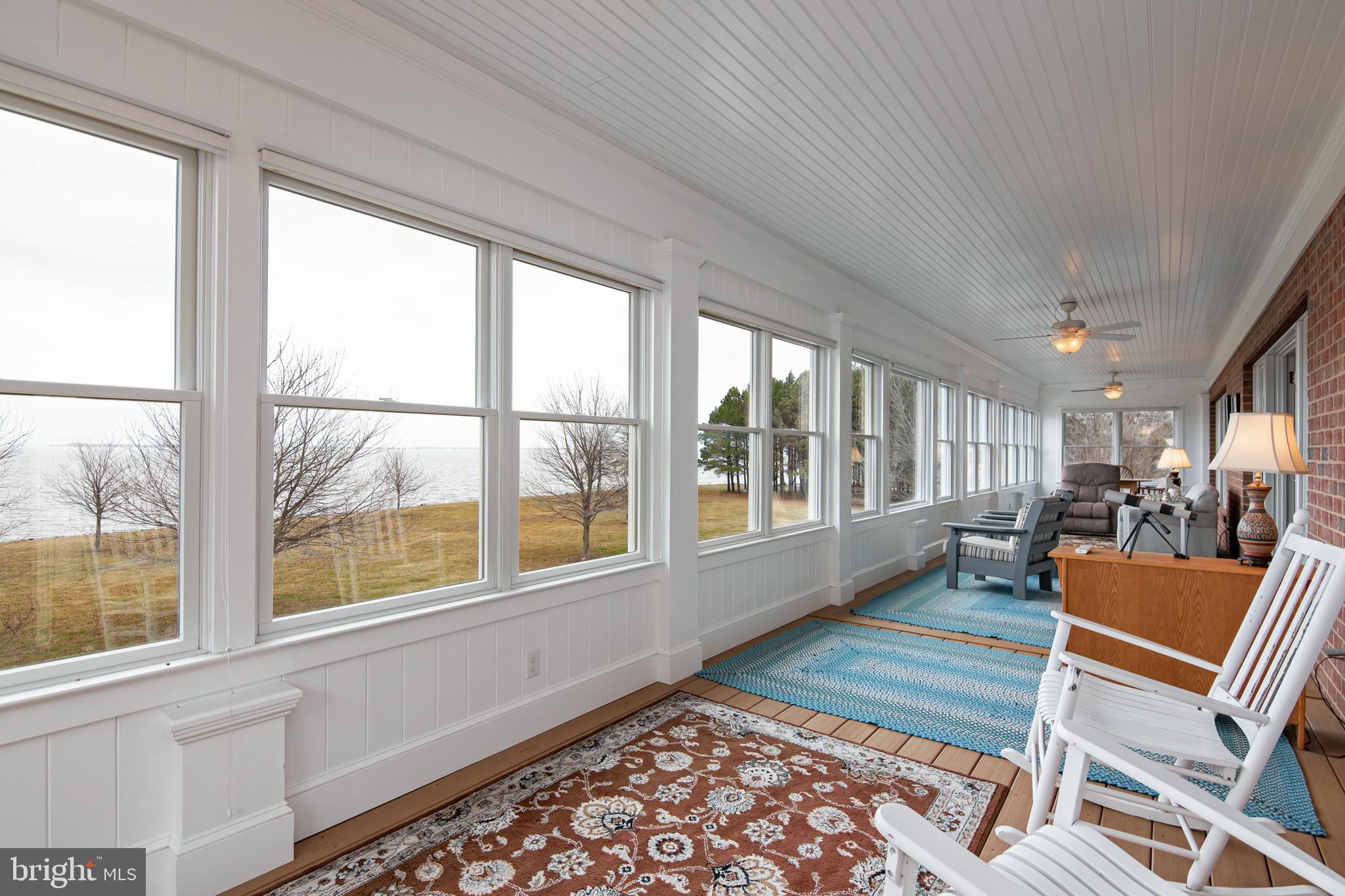 8781 Tilghman Island Road Wittman, MD 21676 - Photo 32 of 60 a room with furniture and a large window