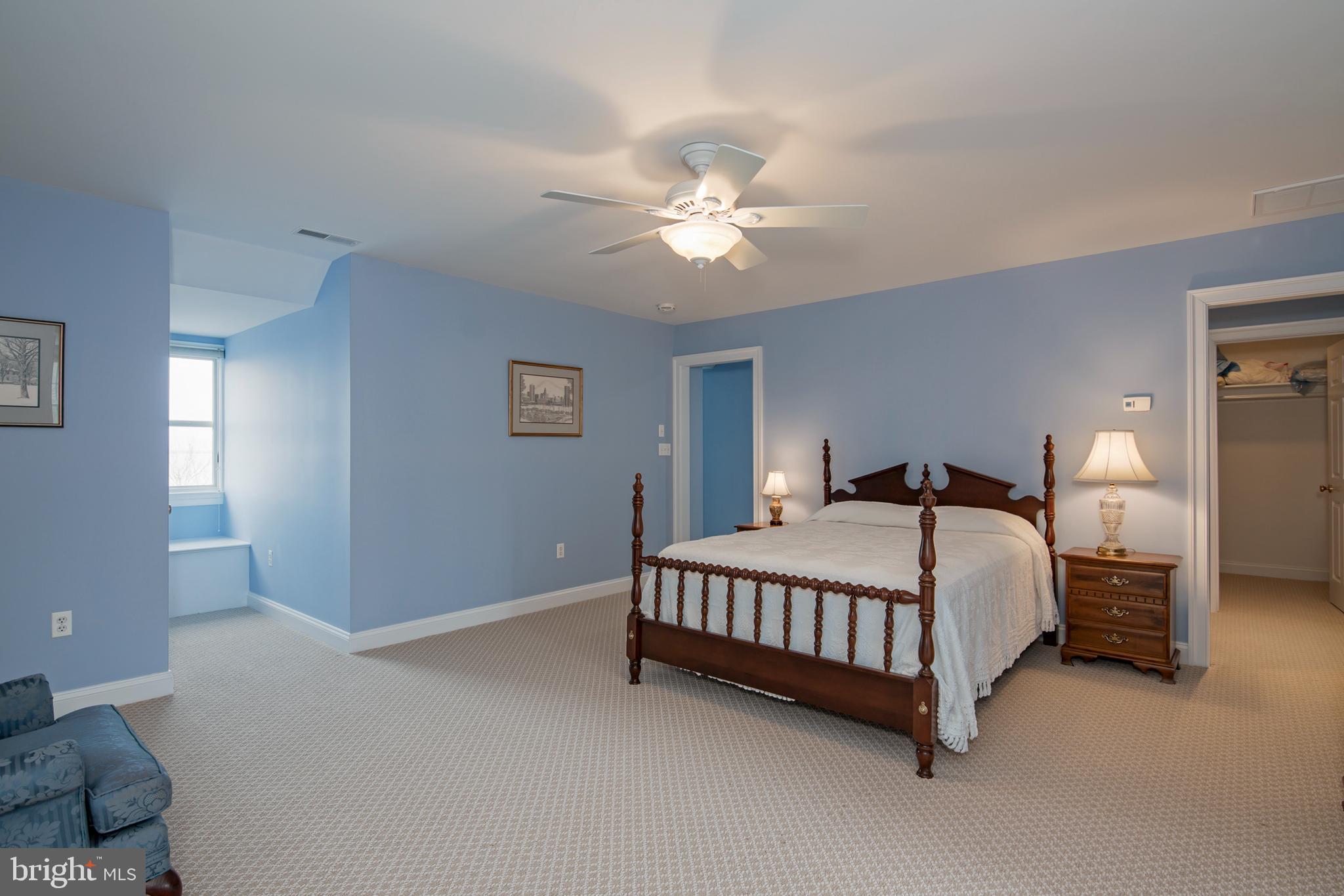 8781 Tilghman Island Road Wittman, MD 21676 - Photo 36 of 60 a bedroom with a bed lamp and a ceiling fan