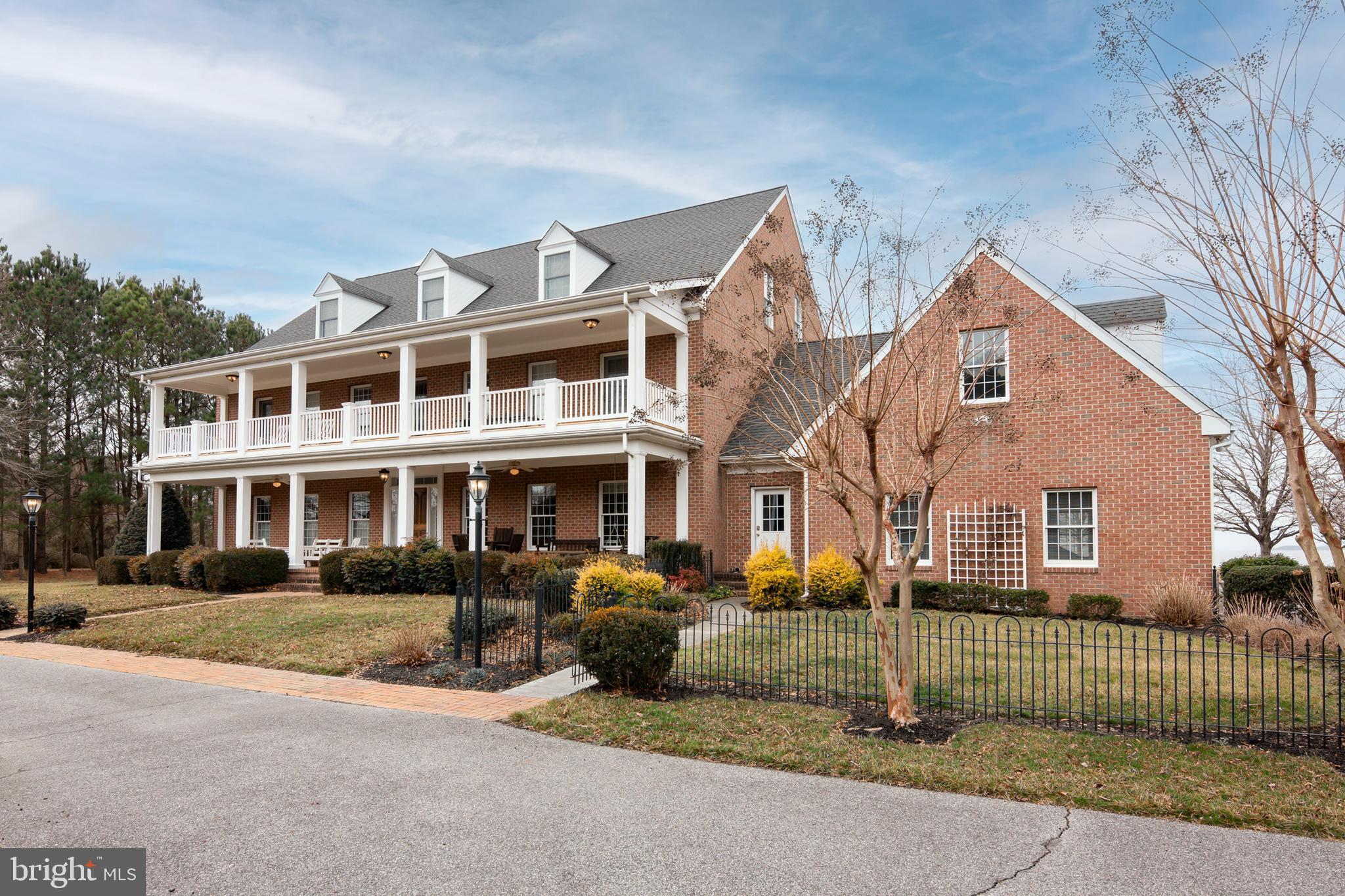 8781 Tilghman Island Road Wittman, MD 21676 - Photo 4 of 60 a front view of a house with a garden