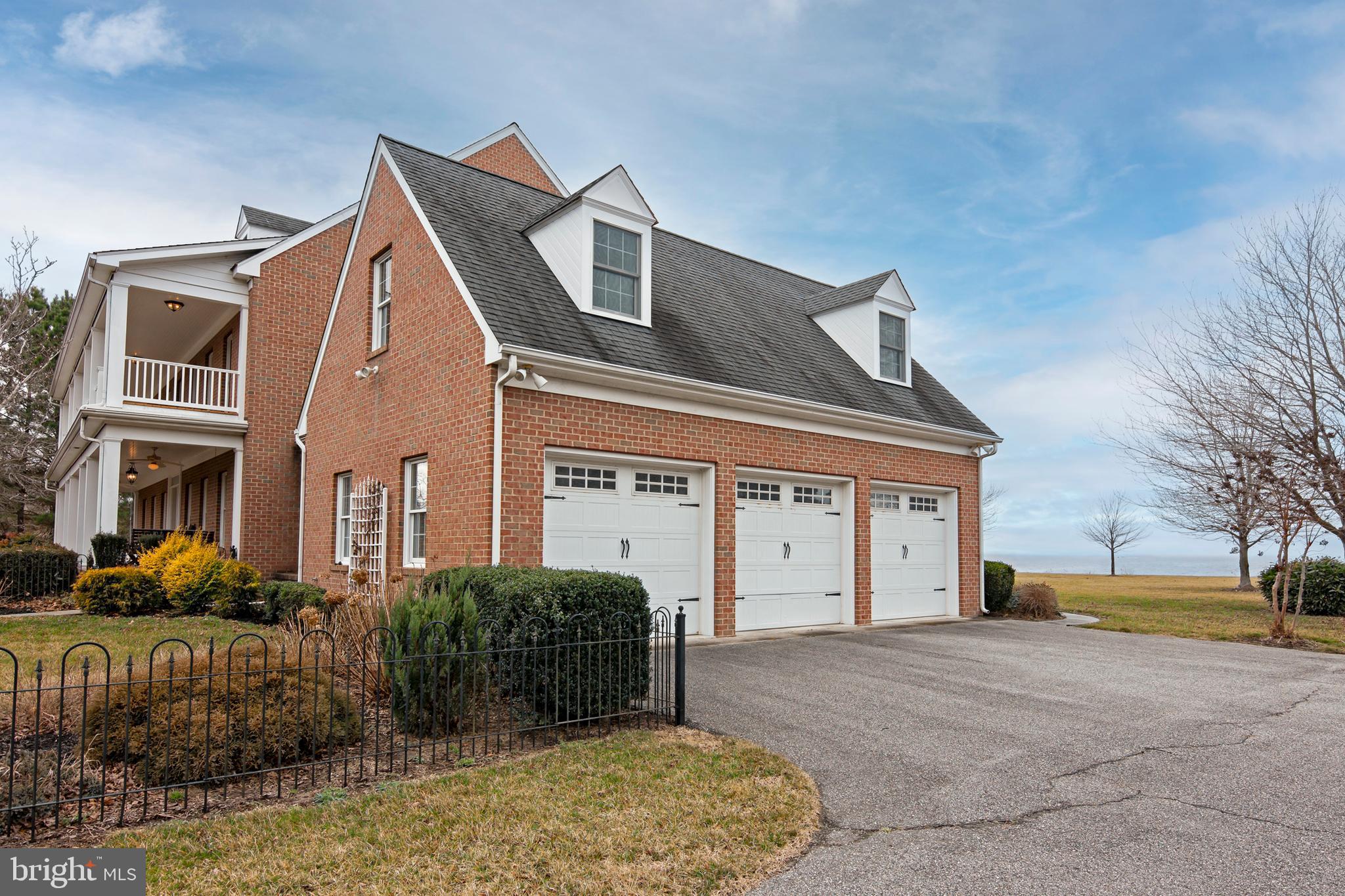 8781 Tilghman Island Road Wittman, MD 21676 - Photo 5 of 60 a front view of a house with a yard and garage