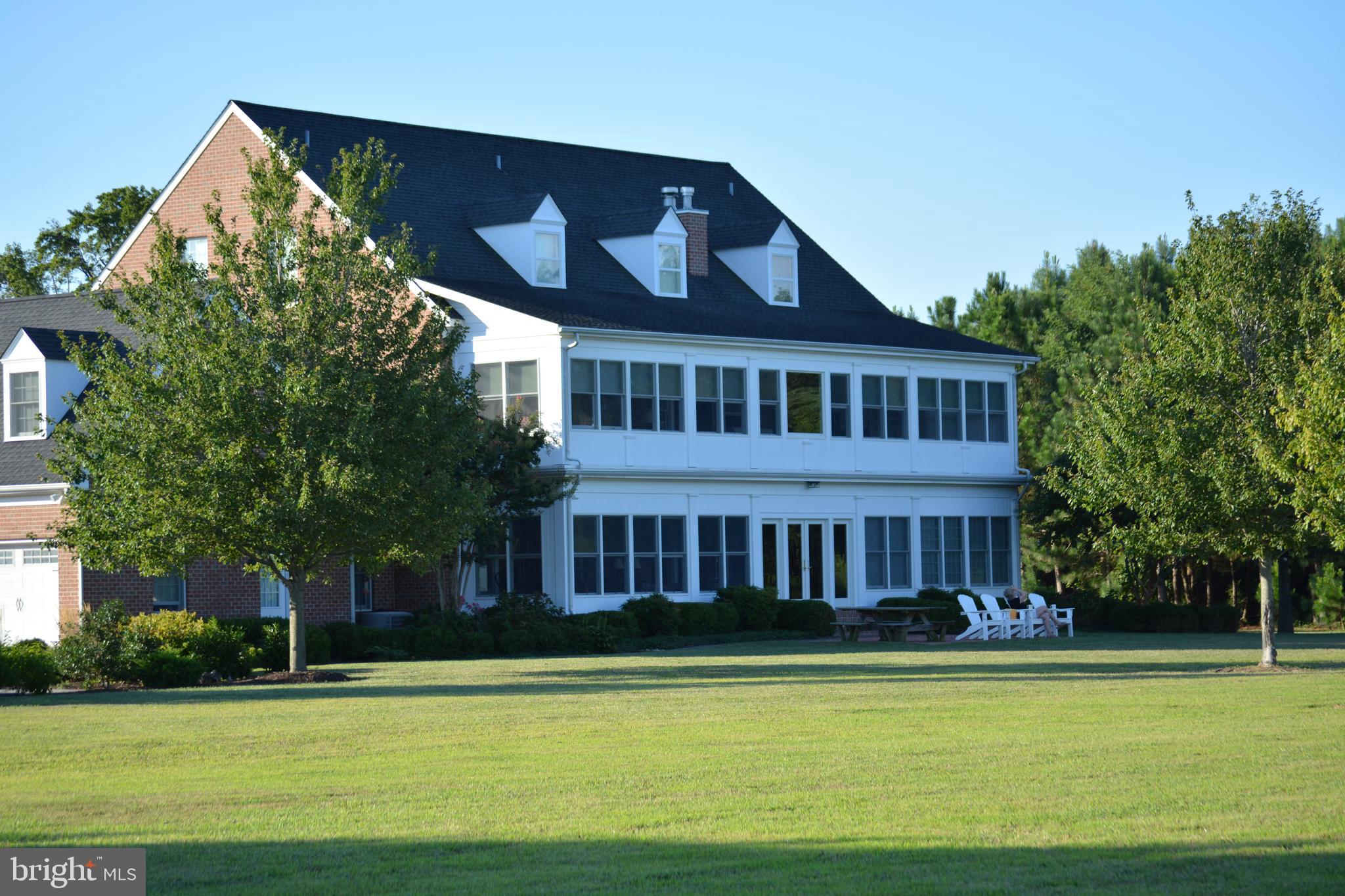 8781 Tilghman Island Road Wittman, MD 21676 - Photo 9 of 60 a front view of a house with a garden