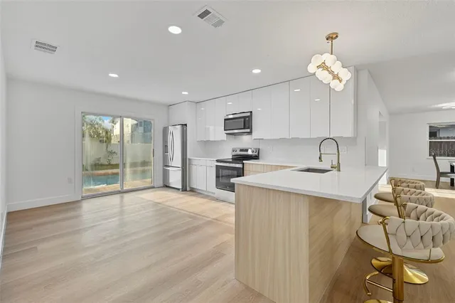 a view of a big room with wooden floor and ceiling fan