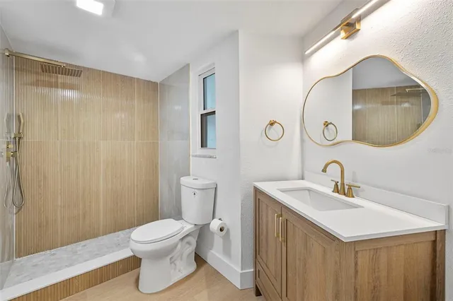 a bathroom with a sink a toilet and a mirror