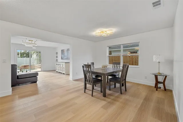 a view of a house with swimming pool and sitting area