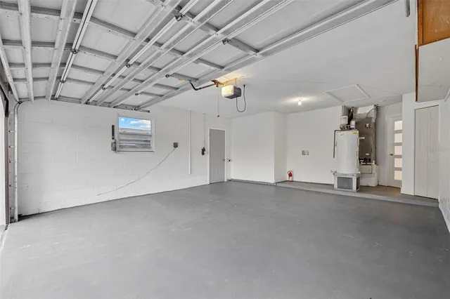 a front view of a house with a garden and trees