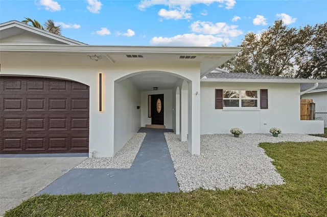 a kitchen with stainless steel appliances granite countertop a sink a stove and a wooden floors