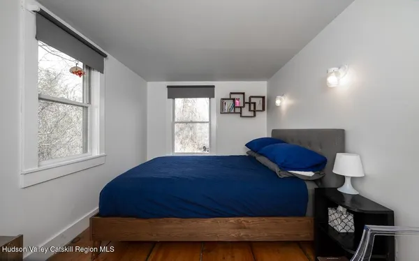 a bedroom with a bed and window