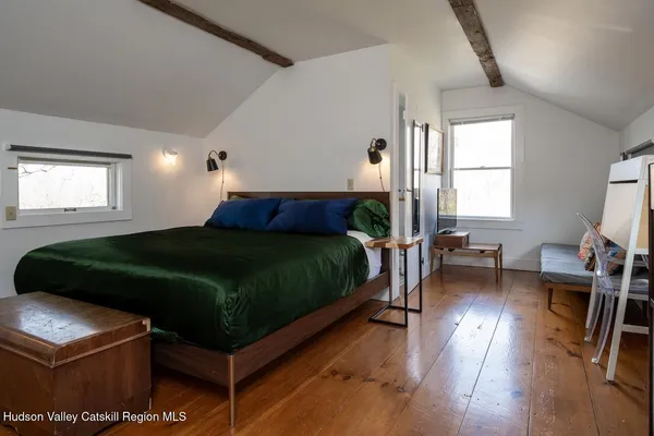 a bedroom with a bed window and a table