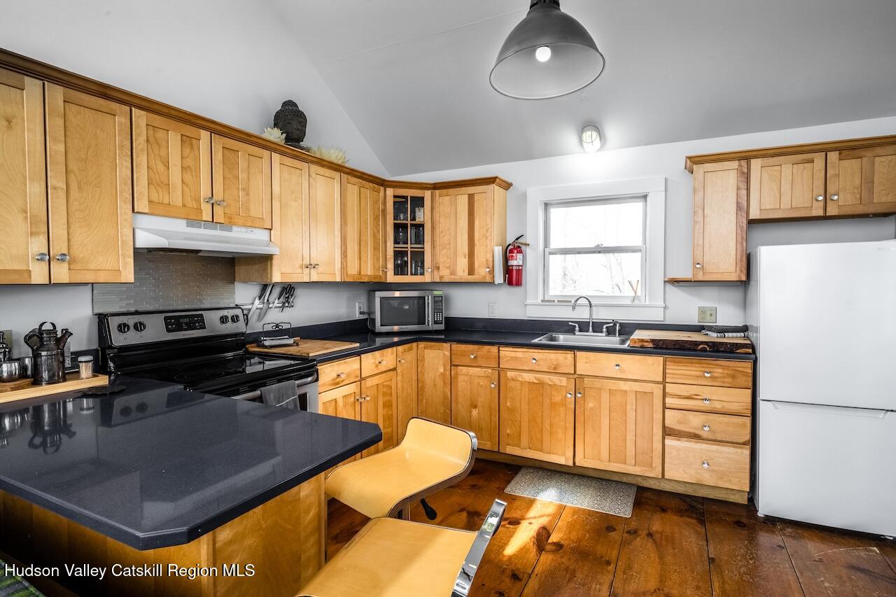 17 Rothvoss Road Ancramdale, NY 12503 - Photo 6 of 16 a kitchen with stainless steel appliances granite countertop a sink dishwasher stove and cabinets with wooden floor