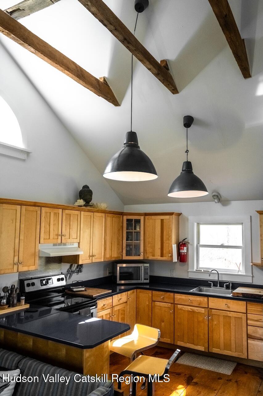 17 Rothvoss Road Ancramdale, NY 12503 - Photo 7 of 16 a kitchen with stainless steel appliances granite countertop a sink a stove and a wooden cabinets
