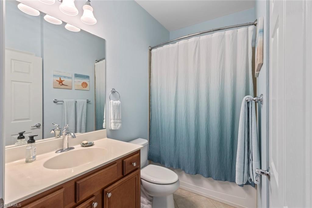 5868 Constitution Street Ave Maria, FL 34142 - Photo 17 of 33 a bathroom with a sink a toilet and shower curtain
