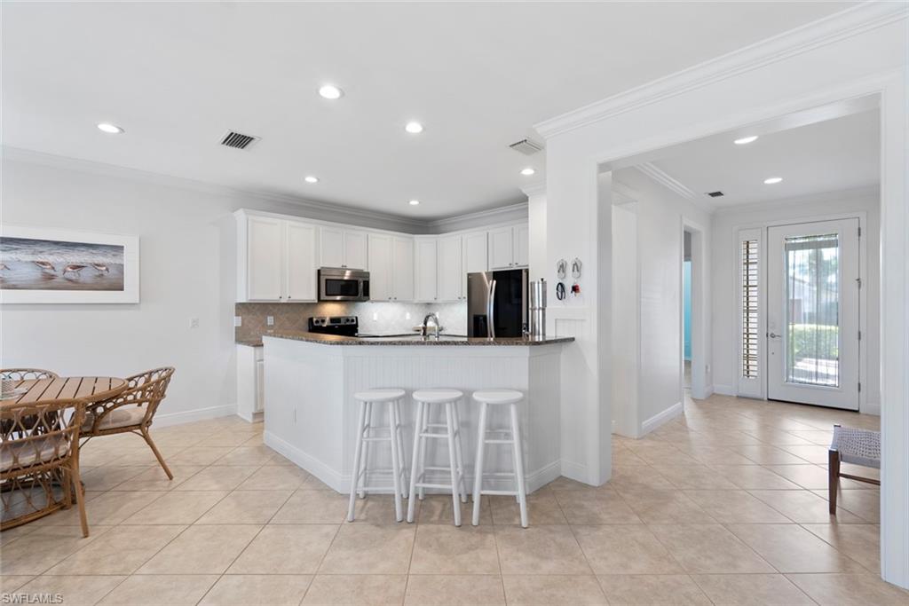 5868 Constitution Street Ave Maria, FL 34142 - Photo 2 of 33 a kitchen with stainless steel appliances granite countertop a refrigerator and a stove top oven