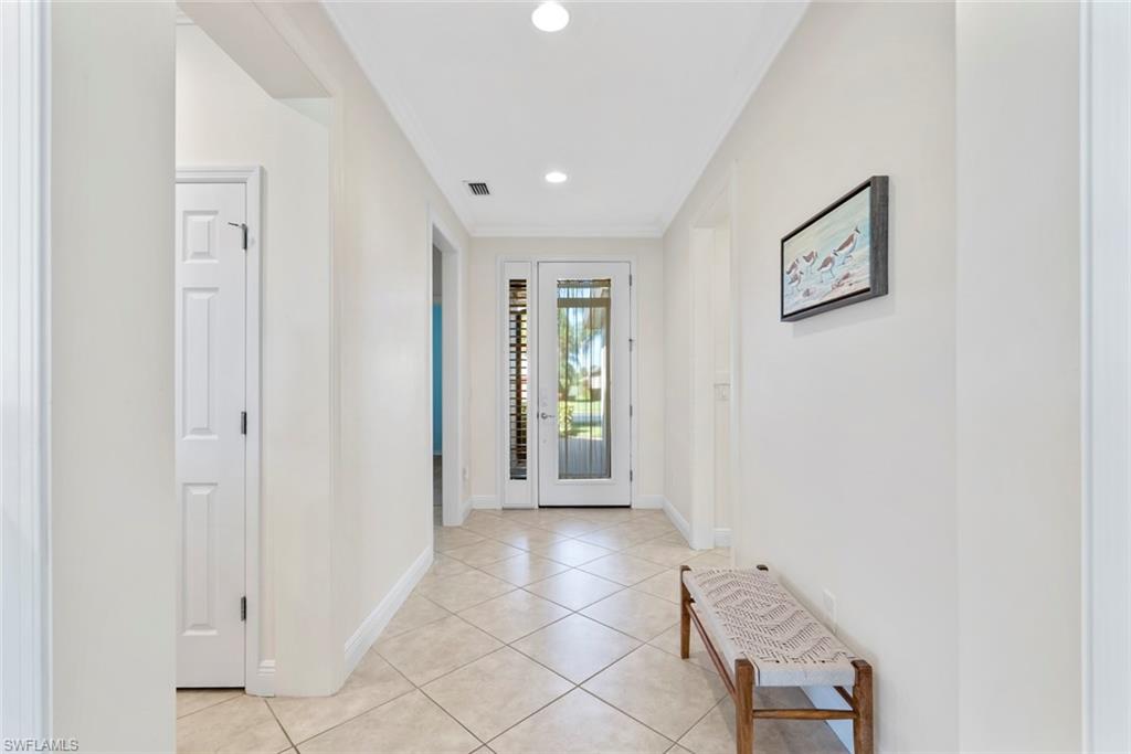 5868 Constitution Street Ave Maria, FL 34142 - Photo 5 of 33 a view of a hallway with wooden floor and a bathroom