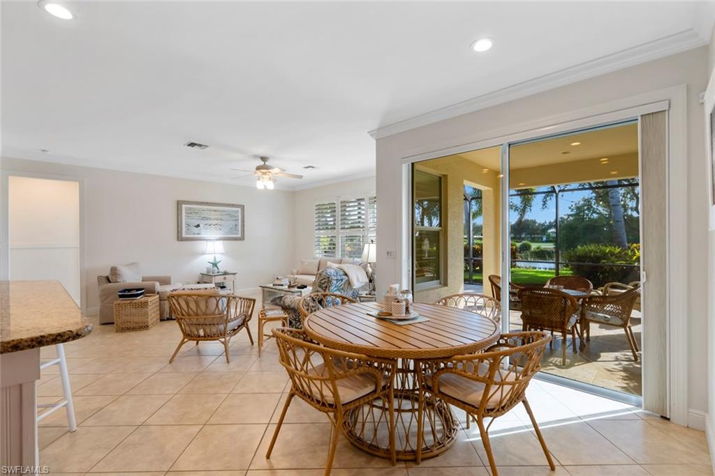 5868 Constitution Street Ave Maria, FL 34142 - Photo 7 of 33 a view of a dining room with furniture and wooden floor