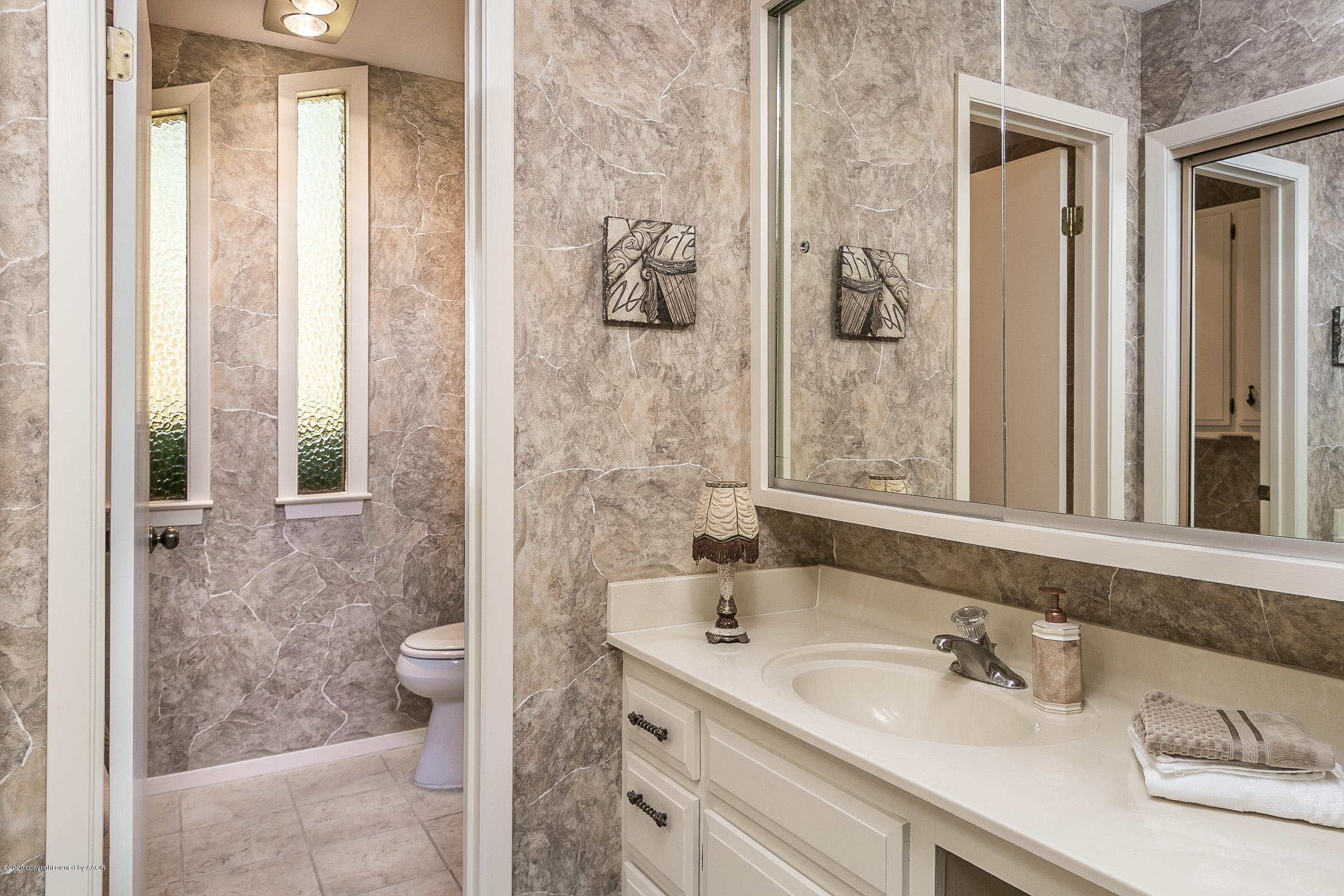 4609 Journey Street Amarillo, TX 79110 - Photo 12 of 30 a bathroom with a sink and a mirror