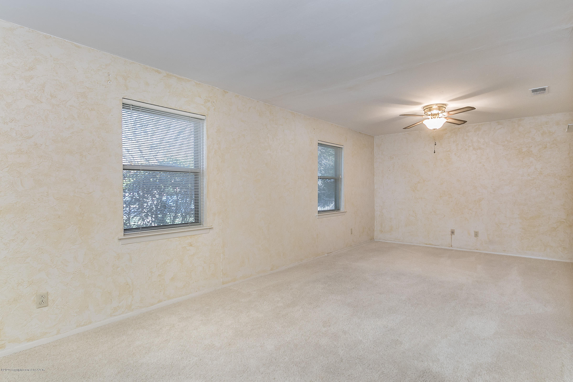 4609 Journey Street Amarillo, TX 79110 - Photo 14 of 30 a view of an empty room with a ceiling fan
