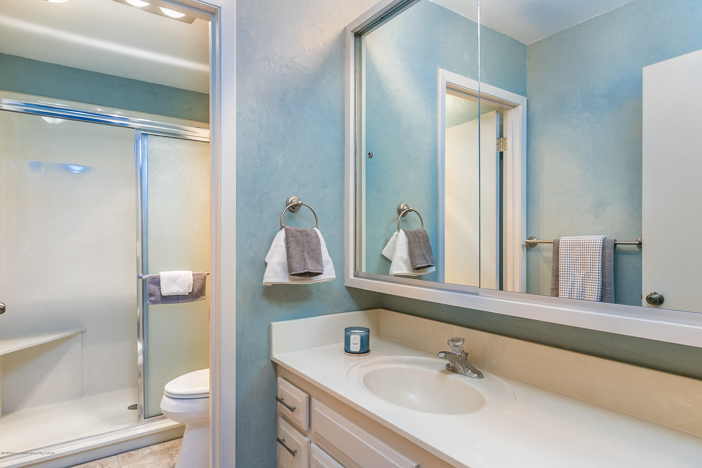 4609 Journey Street Amarillo, TX 79110 - Photo 16 of 30 a bathroom with a sink a toilet and shower