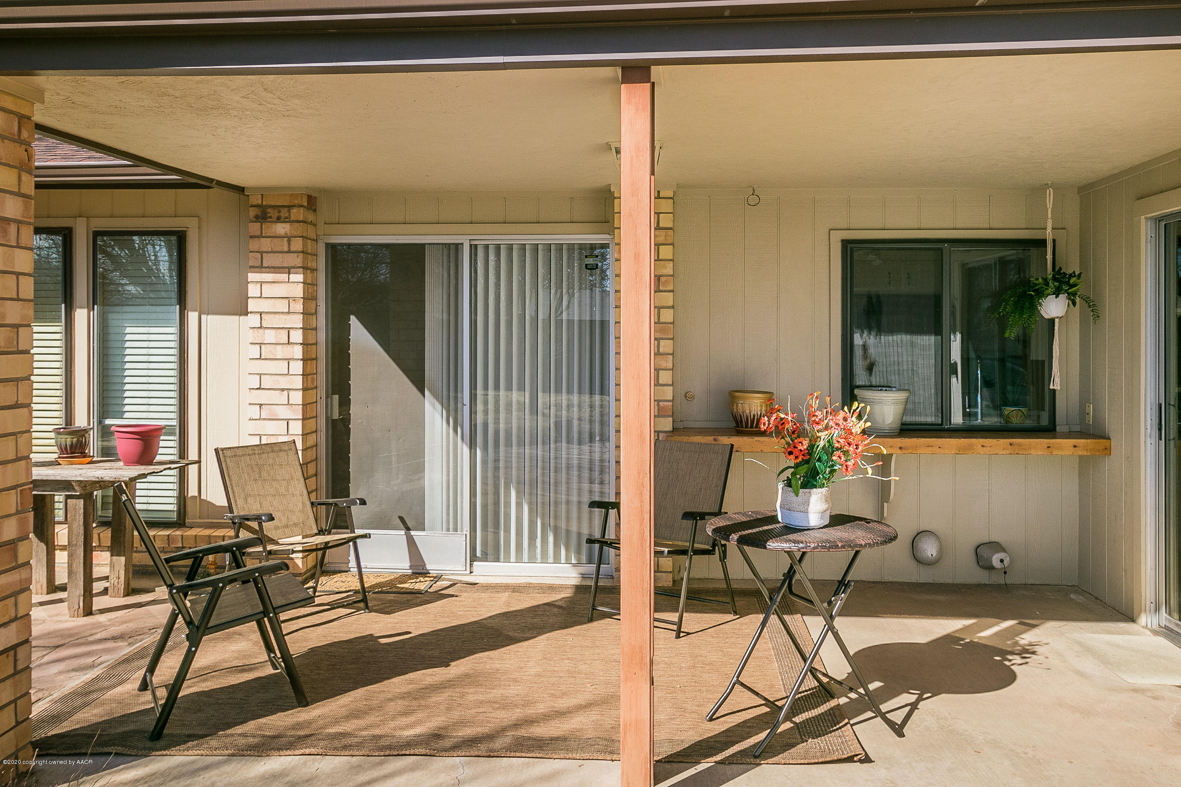 4609 Journey Street Amarillo, TX 79110 - Photo 23 of 30 a patio with table and chairs and potted plants