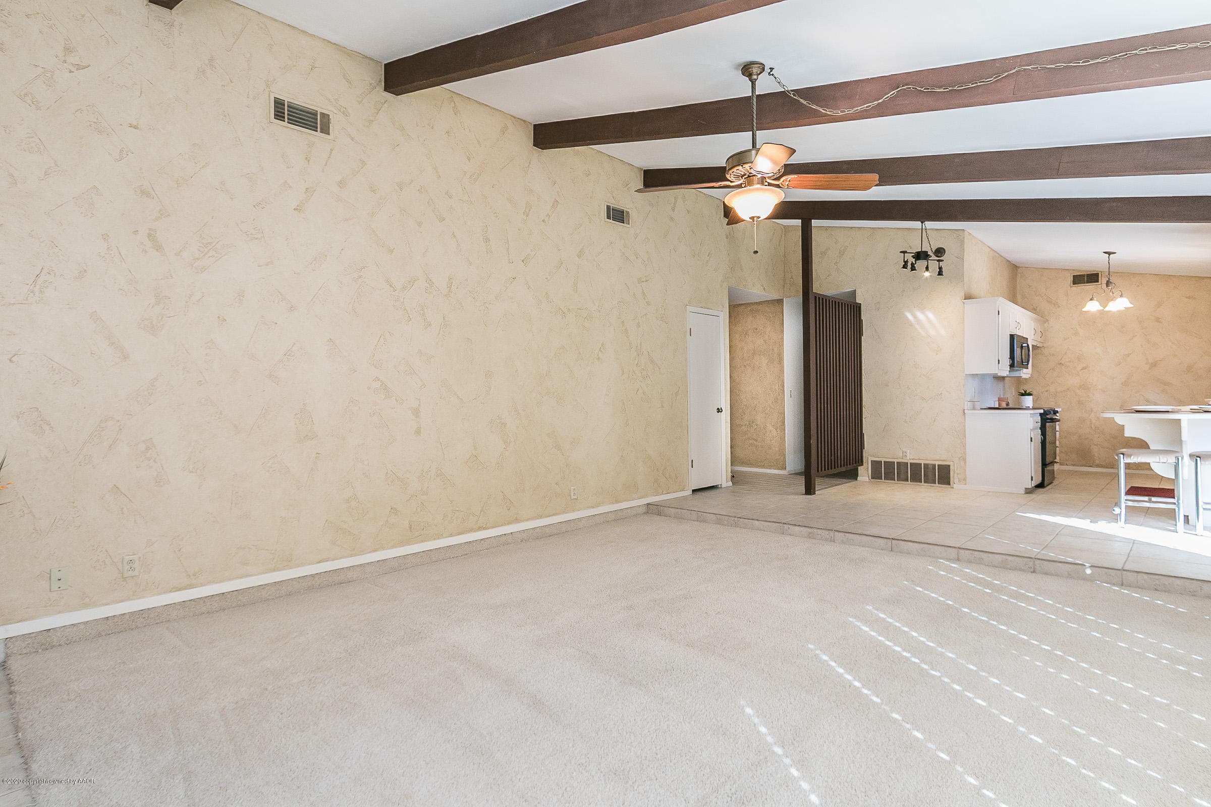 4609 Journey Street Amarillo, TX 79110 - Photo 5 of 30 a view of a hallway with a white walls and chandelier fan