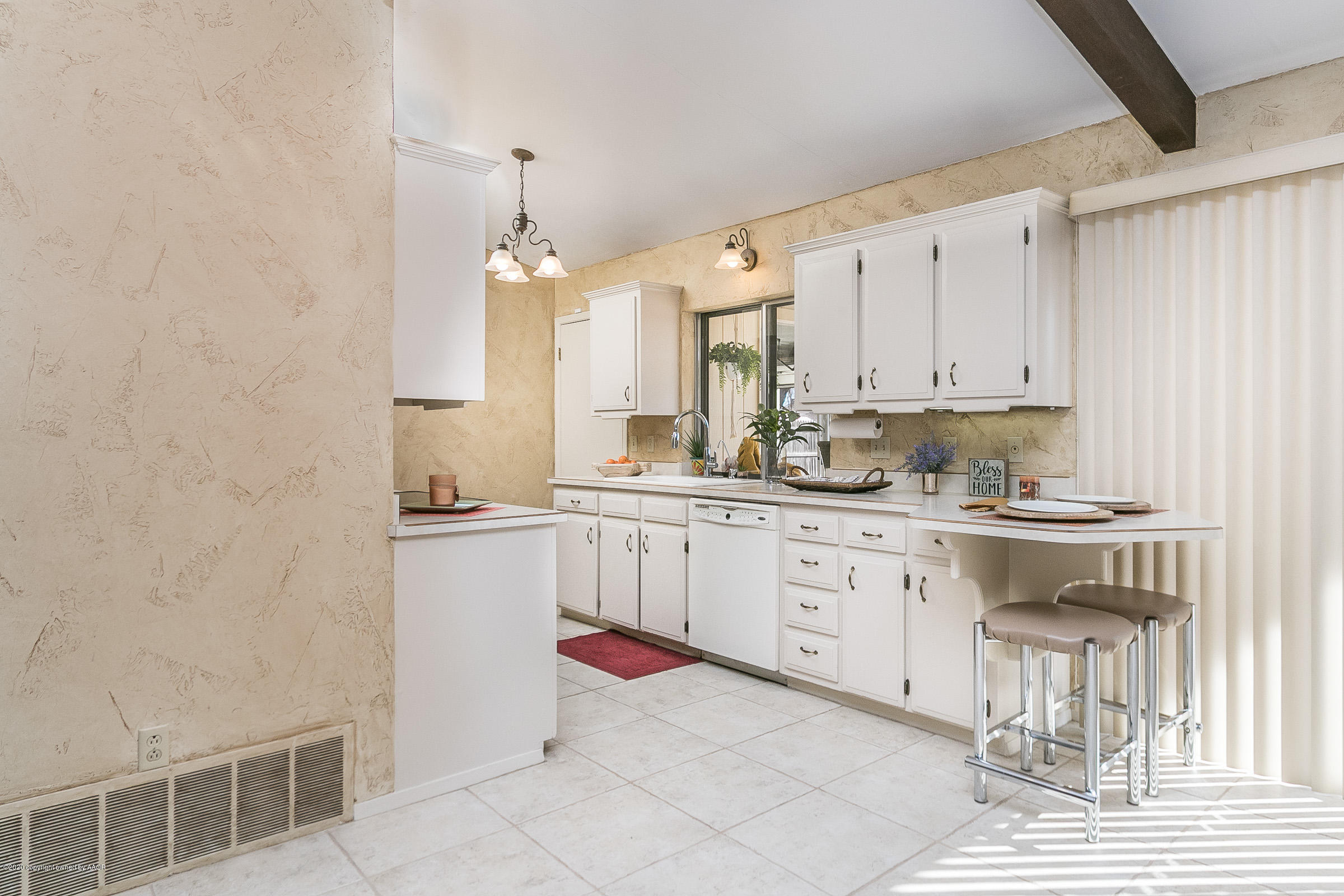 4609 Journey Street Amarillo, TX 79110 - Photo 6 of 30 a kitchen with cabinets appliances and a counter top
