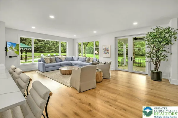 a living room with fireplace furniture and a large window