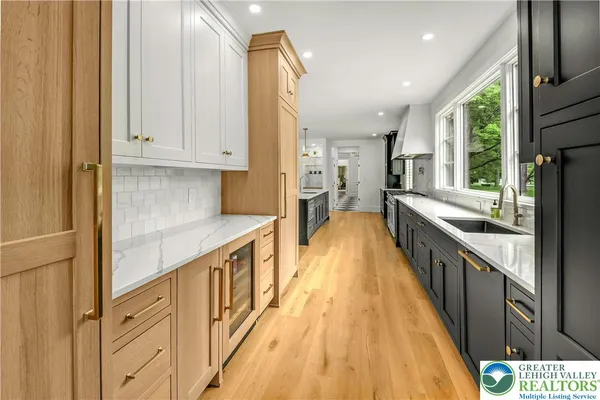 a bathroom with a sink a vanity and a large window