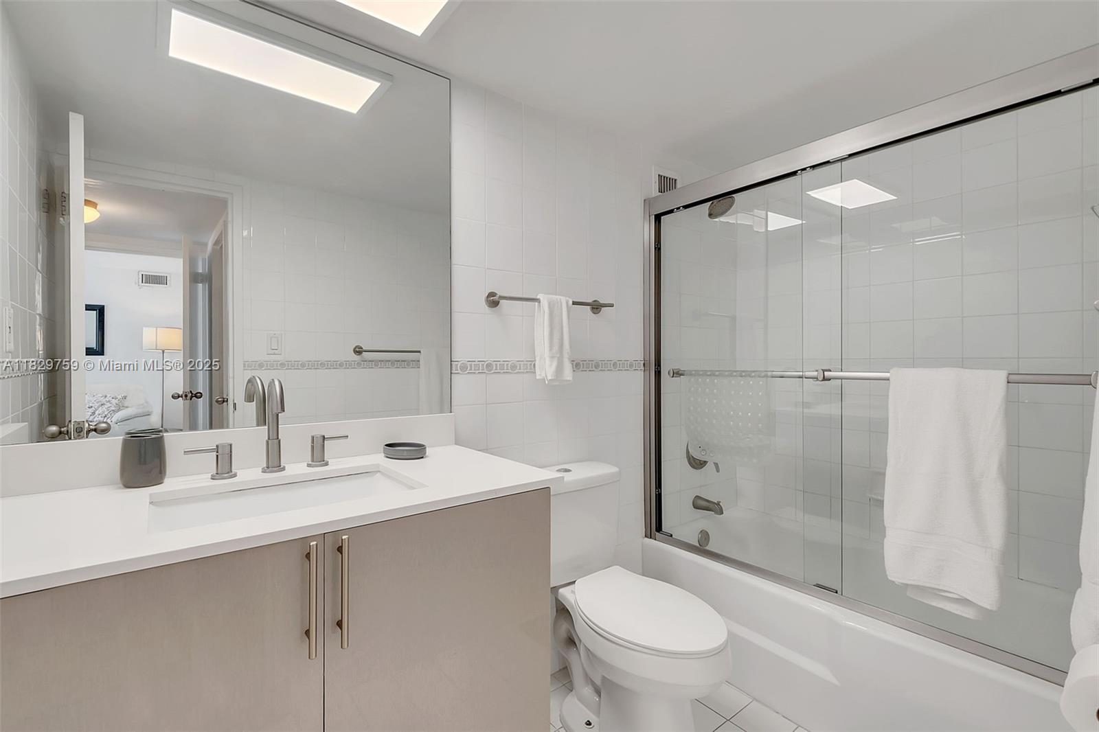 5151 Collins Avenue, Unit 729 Miami Beach, FL 33140 - Photo 12 of 35 a bathroom with a sink toilet and shower