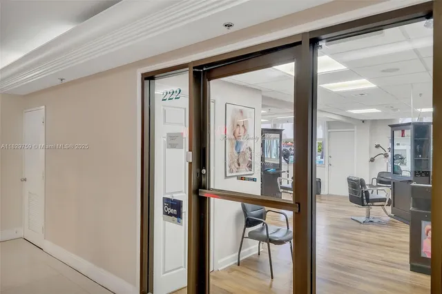 a view of a hallway with wooden floor windows and a livingroom