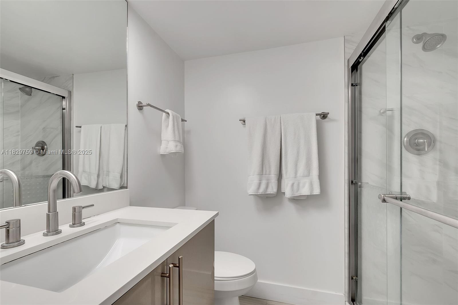 5151 Collins Avenue, Unit 729 Miami Beach, FL 33140 - Photo 8 of 35 a bathroom with a sink toilet double vanity and shower