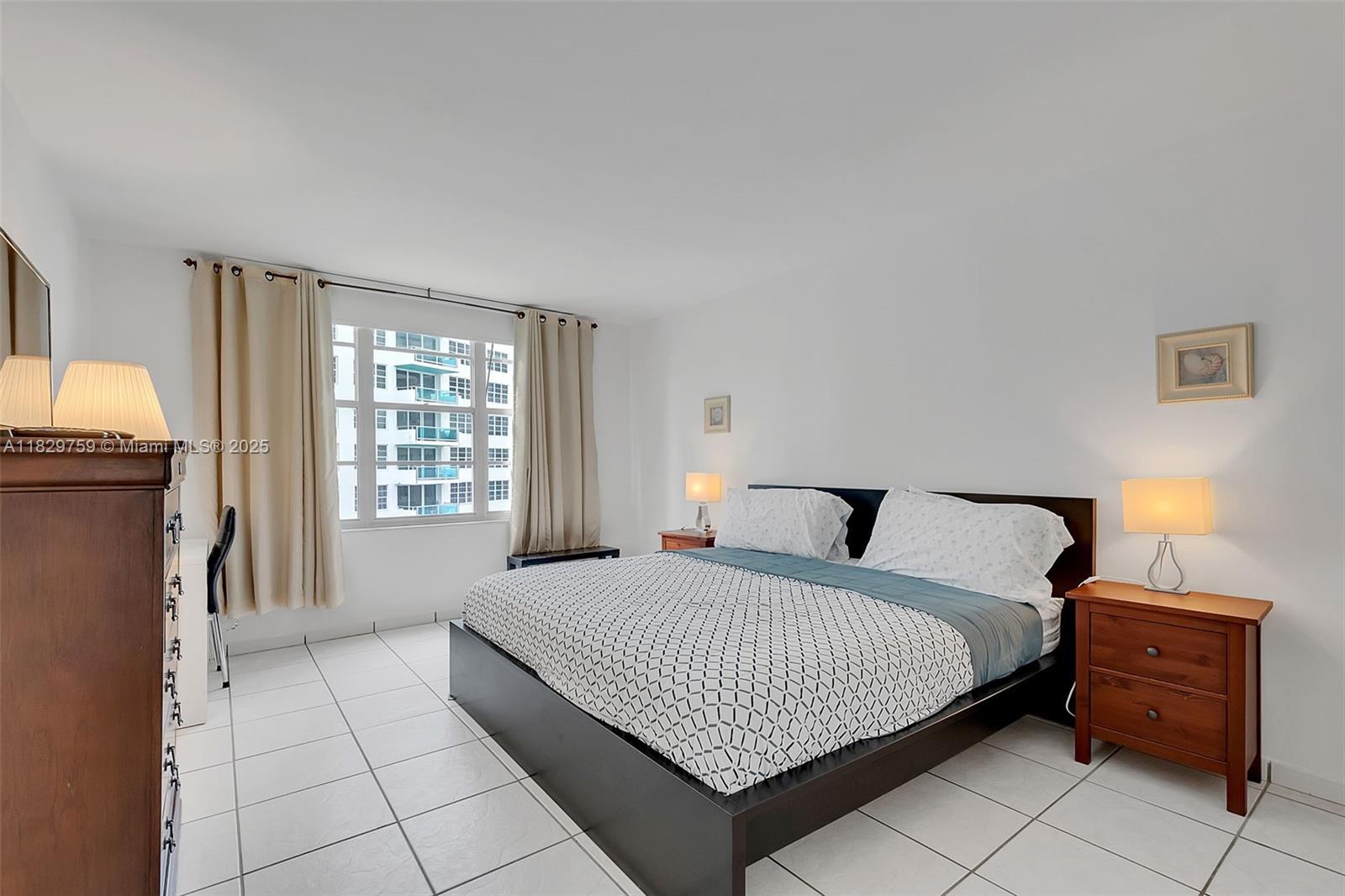 5151 Collins Avenue, Unit 729 Miami Beach, FL 33140 - Photo 10 of 35 a bedroom with a bed and a window