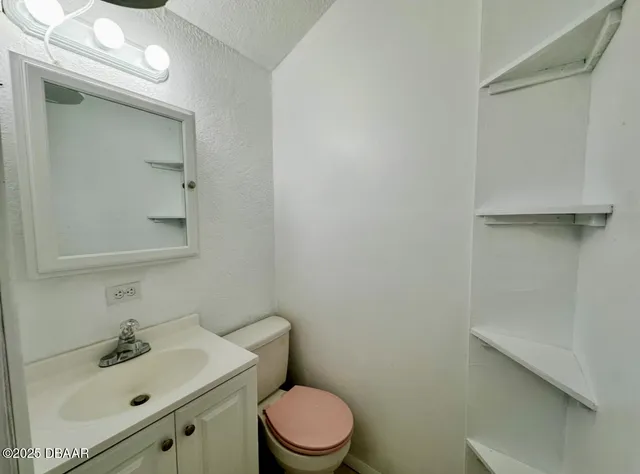 a bathroom with a sink mirror and toilet